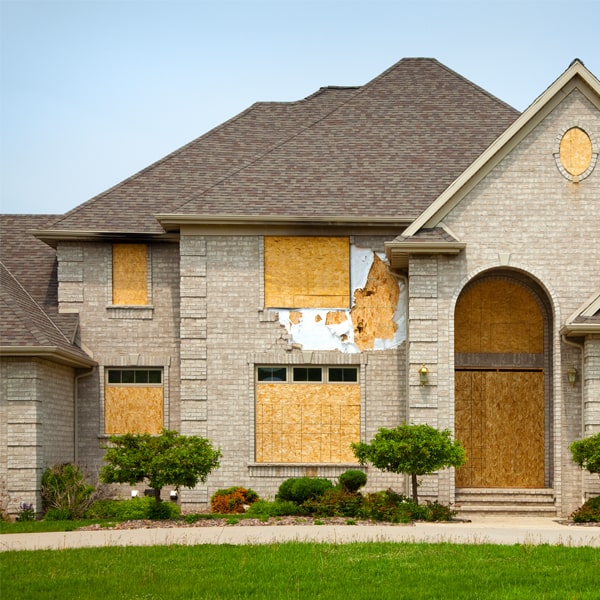 what materials are used to board up the windows doors and other openings to ensure maximum security and safety in Sage MI